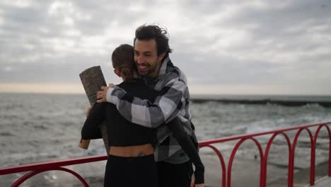 couple hugging on the beach after yoga