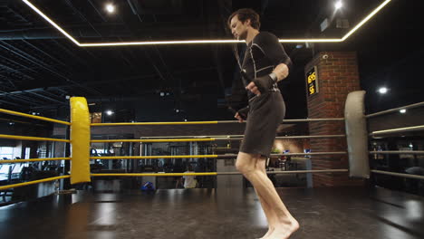 energetic sport man making jumps at gym. male boxer exercising in sport club