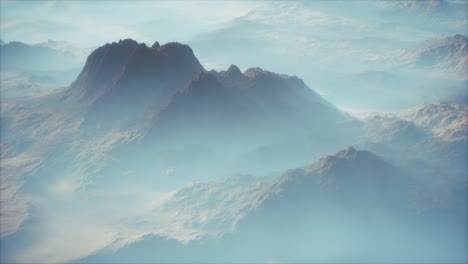 distant mountain range and thin layer of fog on the valleys