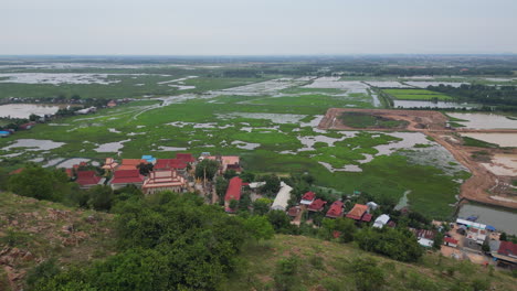 phnom krom hill fly over above cambodian village 4k