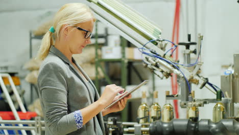 woman uses a tablet in a winery