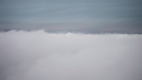 flying above the feld of dense white clouds