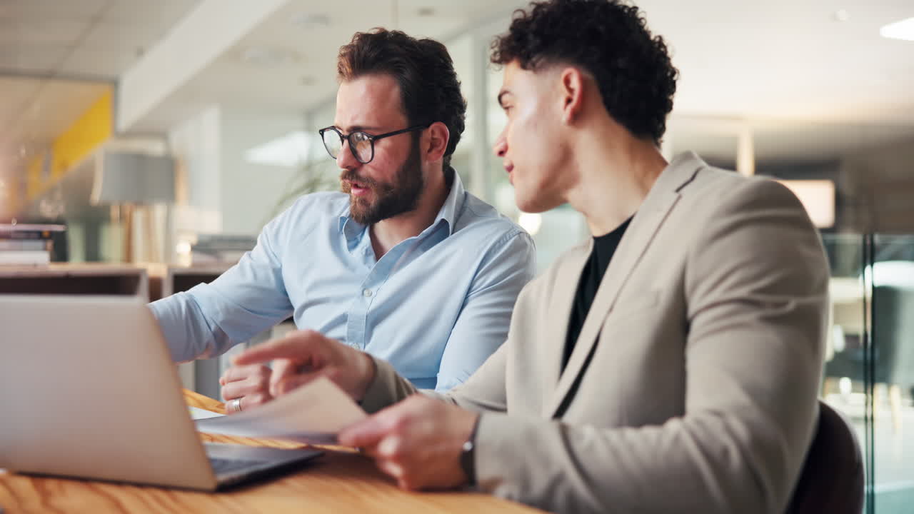Two businessmen in a meeting discussing work