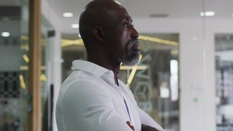 Portrait-of-smiling-african-american-businessman-in-white-shirt-standing-in-office