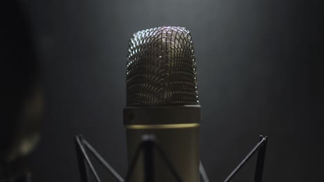 rack focus to a diaphragm microphone in a recording studio