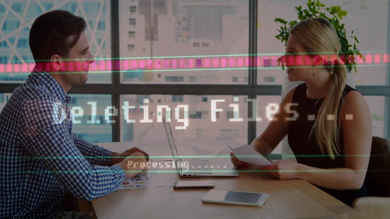 Business meeting with data processing animation over two colleagues at office