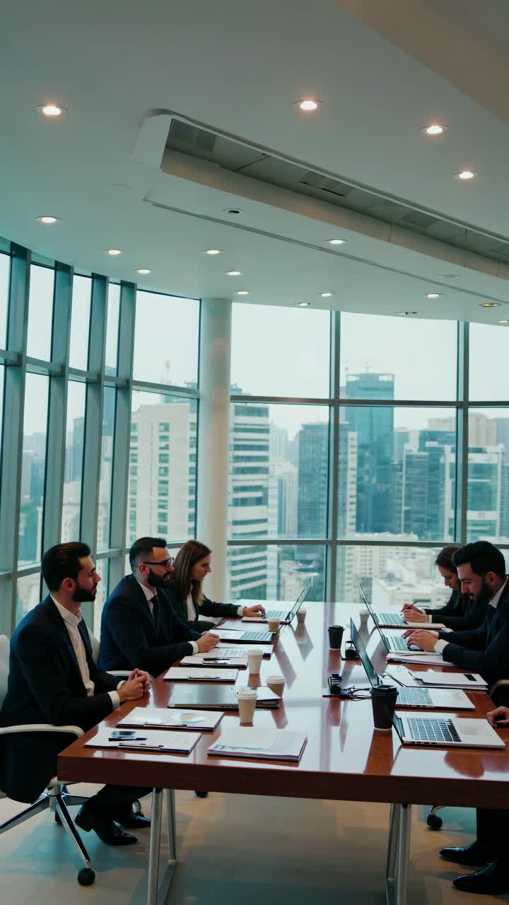High-angle video of a modern conference room with professionals engaged ...