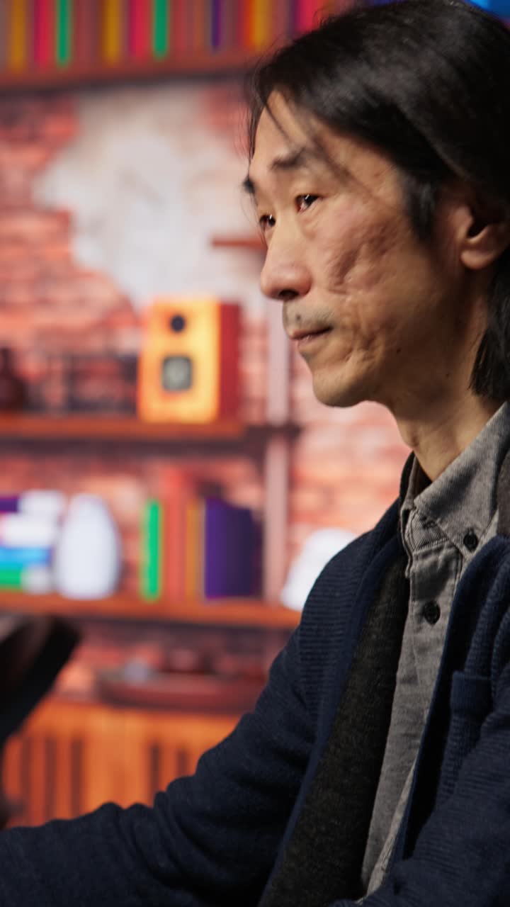 Vertical video Senior manager drinks coffee while working in software development agency