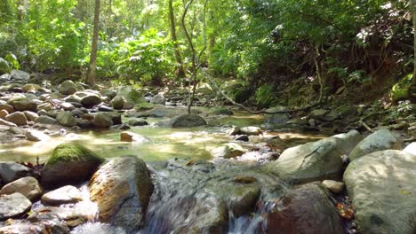 aerial image of a stream amidst small rock formations in santa marta, colombia