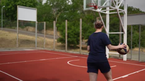 woman playing basketball outdoors