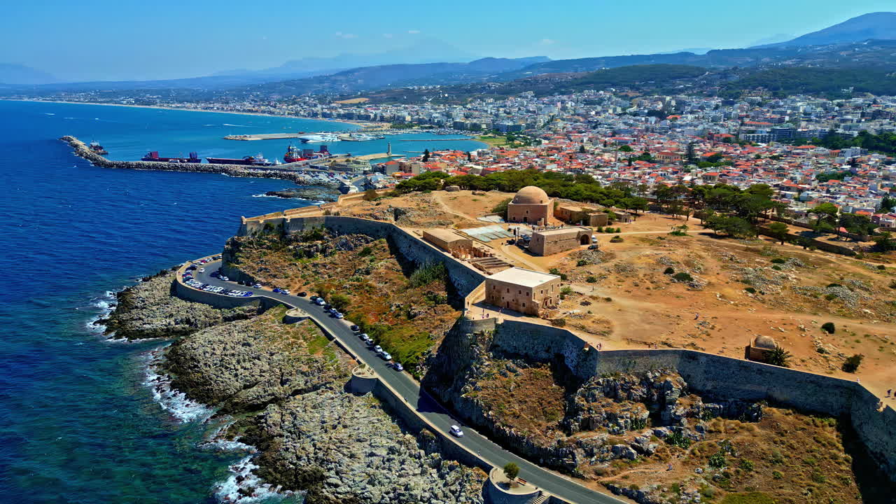 Drone rising away from the Venetian Fortezza Castle, in sunny Rethymno, Greece