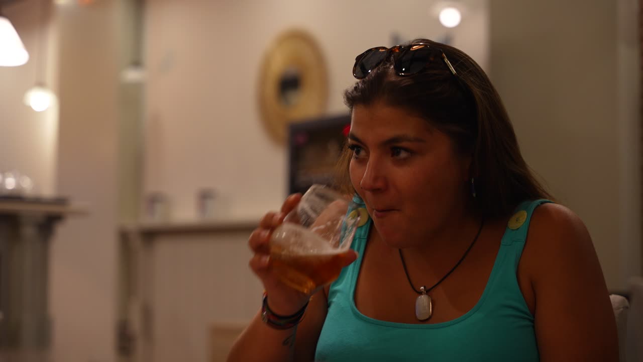 Young woman laughing with her friends dinning at a restaurant
