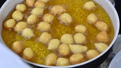 luqaimat balls, the most popular emirati desserts, are being prepared