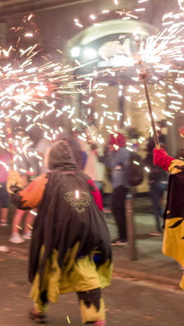 barcelona, spain - 22 september 2023 : crowds in the street for the fire run or correfoc, during la merce festival, barcelona spain in vertical