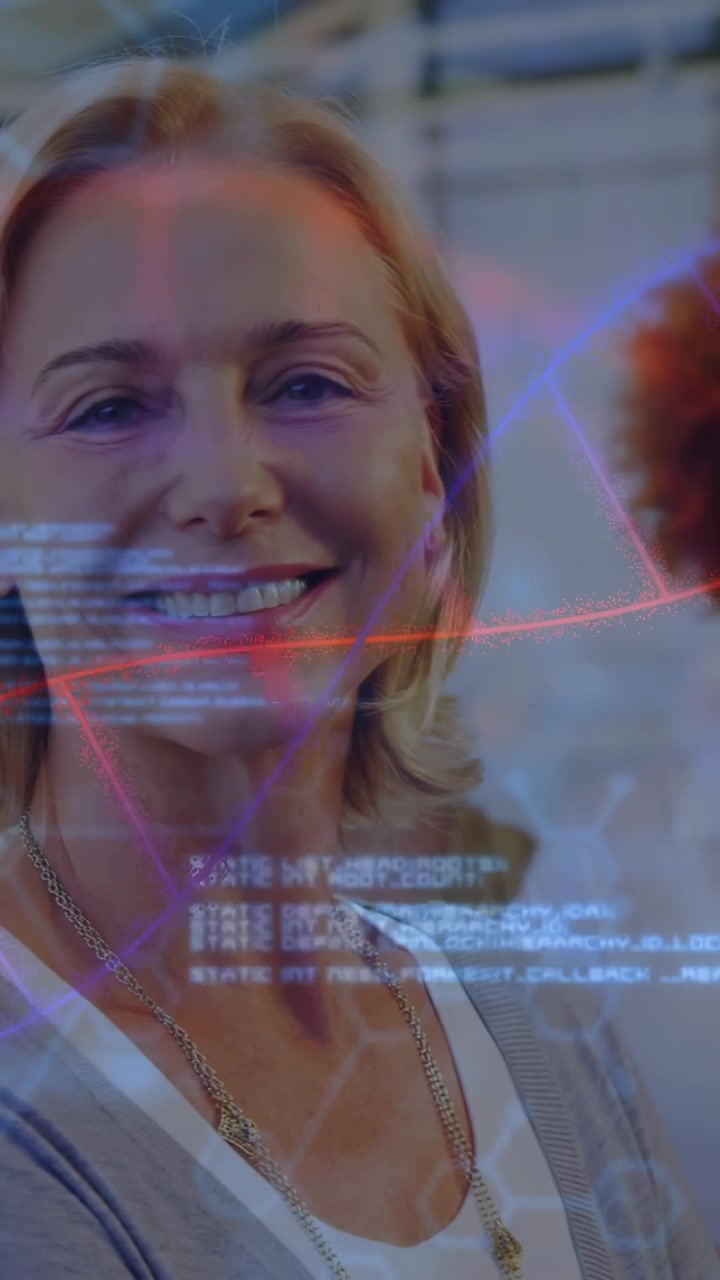 Vertical video: Curly woman with tablet, camera panning to blonde, code sweeping team for tech ad