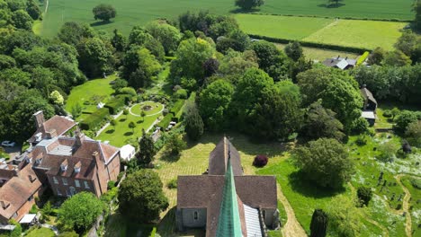 drone shot flying fast towards the village church in barham in kent, uk