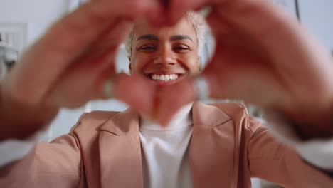 young african american woman shows love gesture
