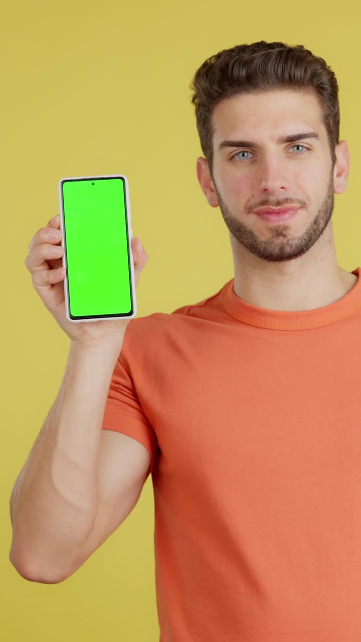 Man Presenting Smartphone with Green Screen