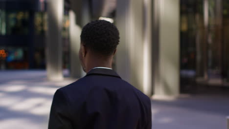 businessman and businesswoman meeting outside offices in the financial district of the city of london uk