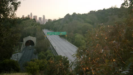empty 110 freeway in los angeles at dusk with downtown skyline view
