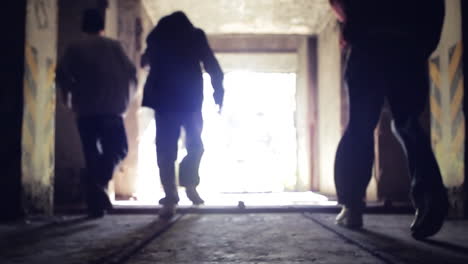 people running through a dark tunnel