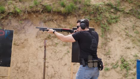 caucasian male shooter reload shotgun and fire gun, olesko shooting range