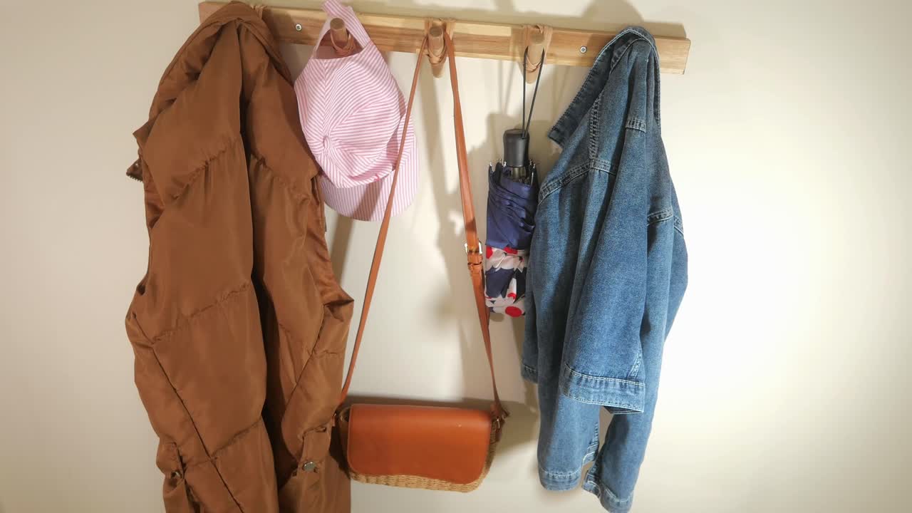 Everyday Items Hanging on a Wooden Coat Rack