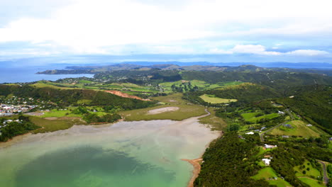 aerial view of a scenic coastal landscape with bay and green hills