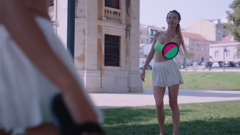 women playing paddleball in a park