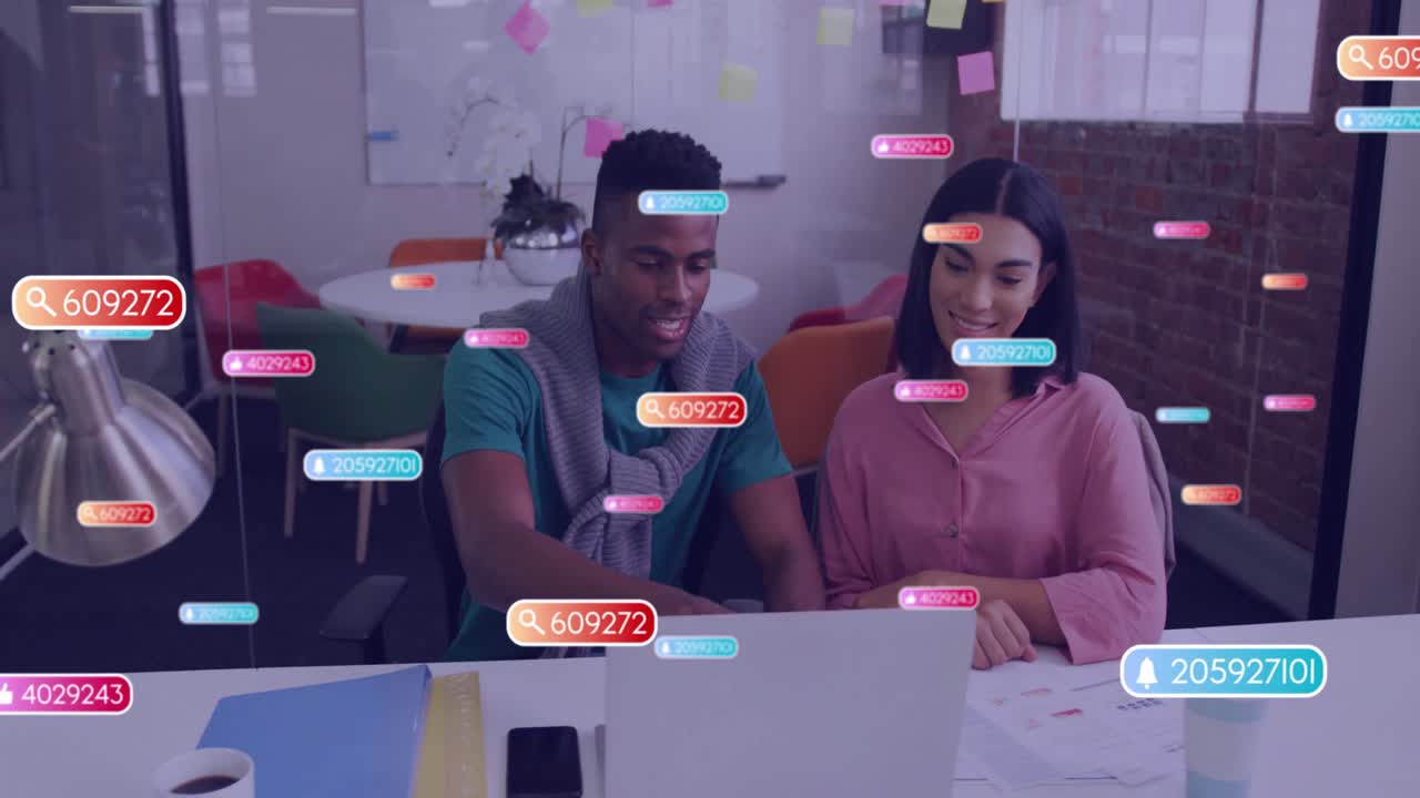 Animation of social media icons with numbers over diverse colleagues discussing work in office