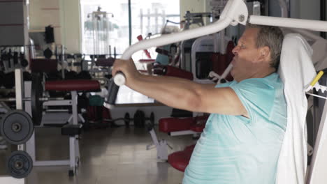 mature man exercising on chest press machine