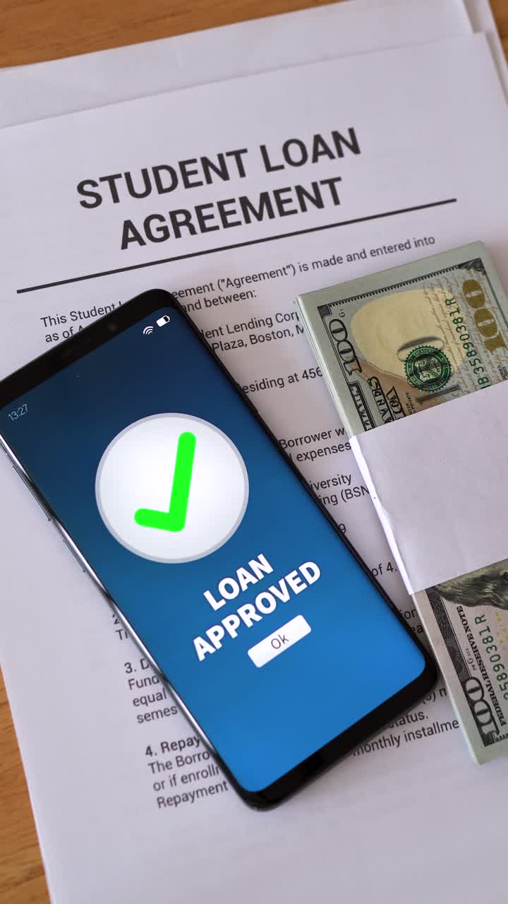 Smartphone notification of student loan approved. Concept of getting in debt to go to college. Vertical shot.