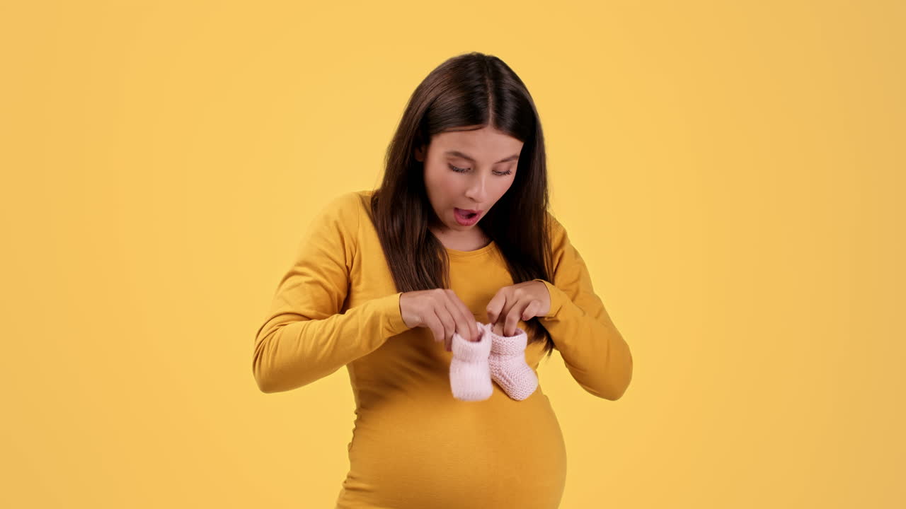 Pregnant Woman Excited About Baby Shoes