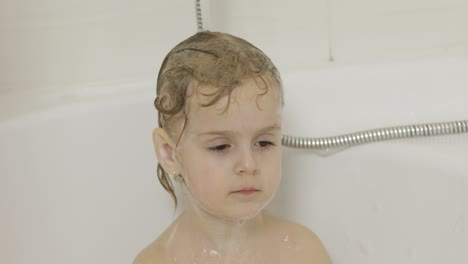 Attractive-three-years-old-girl-takes-a-bath.-Cleaning-and-washing-hair