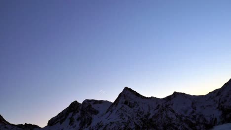 two-planes-flying-over-a-mountain-at-the-same-time-leaving-smoke-trails-behind