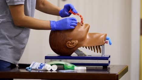 emergency training for save life. demonstrating chest compression on cpr doll