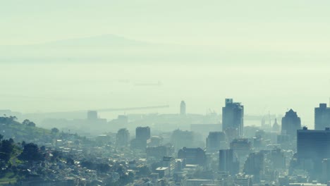 General-view-of-cityscape-with-multiple-modern-buildings-and-shore-covered-in-smog