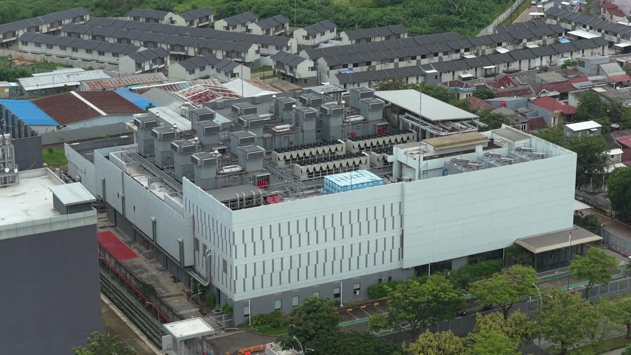 Modern data center building with its cooling system on the roof. Aerial view of a big data and cloud computing facility in jakarta, indonesia
