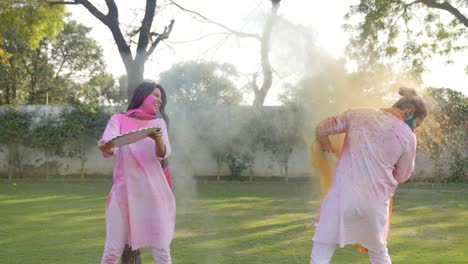 indian wife throwing holi colors on her husband