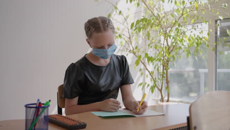 children at school sit in the classroom and raise their hands answering the teacher's questions in protective masks in slow motion