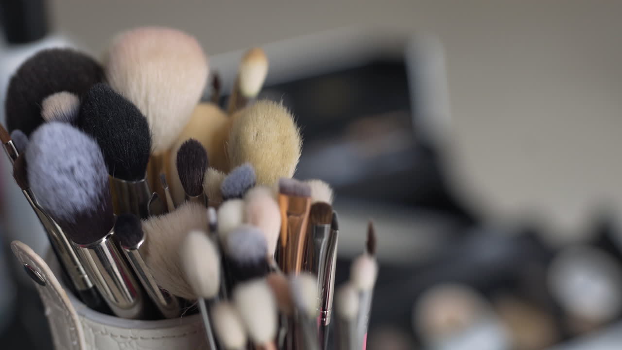Closeup of Makeup Brushes and Cosmetics