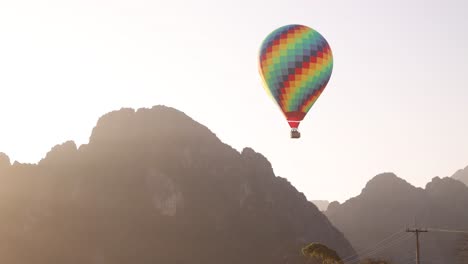 Colorido-Globo-Aerostático-Flotando-Entre-Picos-Montañosos-En-Vang-Vieng,-La-Capital-De-Aventuras-De-Laos.