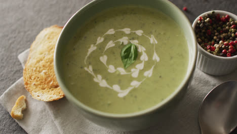 video of green peas soup and ingredients lying on grey surface