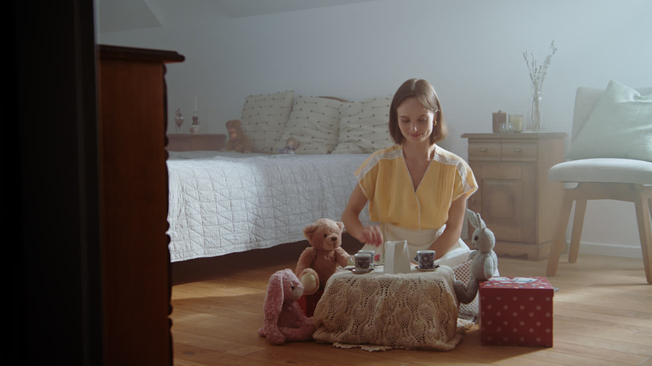 A girl playing with dolls in her room