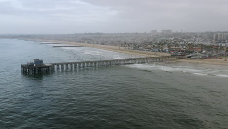 aerial drone shot of newport beach pier, ocean and city - parallax - 4k uhd