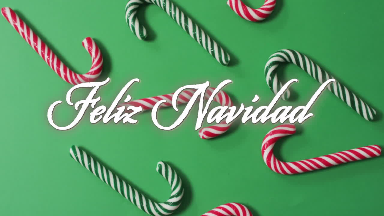 Animation of feliz navidad text over candy canes