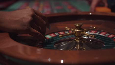 black woman female spinning roulette wheel at casino party in slow motion