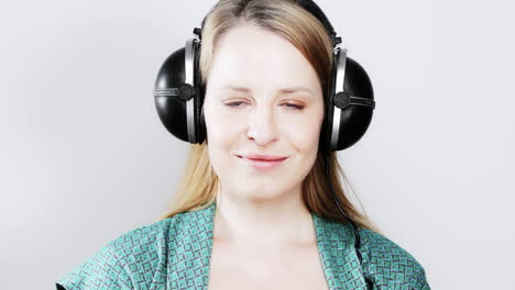 cool female dancer with changing retro headphones to listen to music