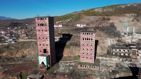 ruined factory with high cement towers and bricks buildings remained from communist era in albania