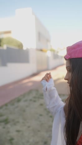 young woman wearing pink baseball cap